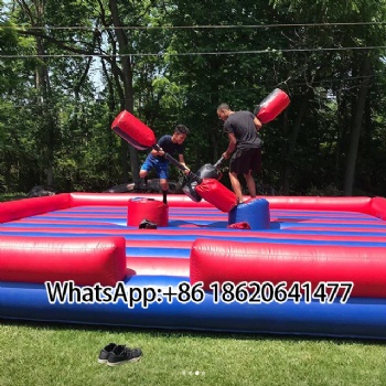Outdoor Inflatable Combat Zone: Pillar - Based Dueling Fun with Padded Weapons